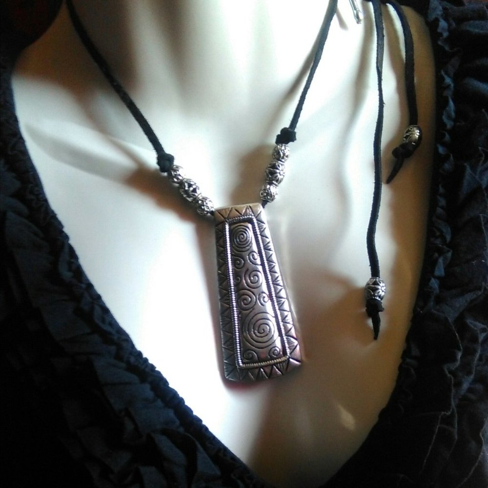 This statement pendant A decadent melange of black enamel necklace